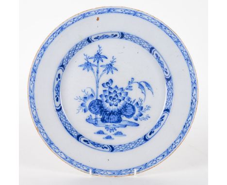 AN ENGLISH DELFTWARE BLUE AND WHITE LARGE PLATECirca 1770
Painted with lotus and bamboo inside a trellis pattern border, 29.5