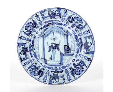 A DUTCH DELFT BLUE AND WHITE CHARGERCirca 1700
Painted in inky blue in Chinese Kraak porcelain style with two figures in an a