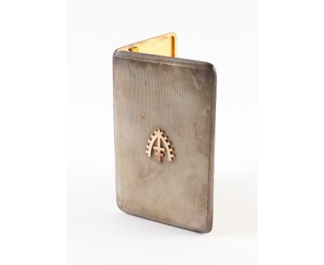 A SILVER RECTANGULAR CIGARETTE CASEThe top applied with a cruciform badge within a stylized wreath, the exterior engine turne