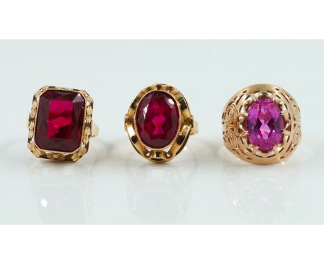 THREE SYNTHETIC GEMSTONE RINGSIncluding two synthetic ruby rings, sizes Q and O 1/2 and a synthetic pink sapphire ring, size 