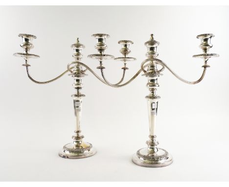 A  PAIR OF SHEFFIELD PLATED THREE LIGHT TABLE CANDELABRA (2)With scrolled detachable arms, decorated with gadrooned rims and 