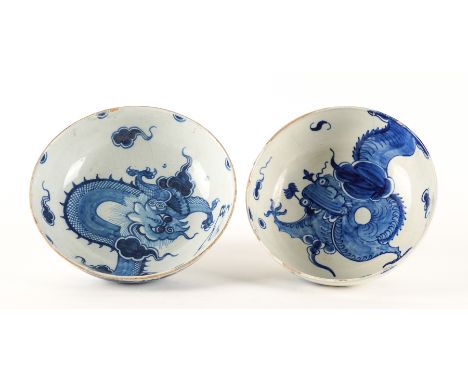 AN ENGLISH DELFTWARE BLUE AND WHITE BOWLCirca 1770
painted with a dragon amongst cloud scrolls, continued on the exterior, 22