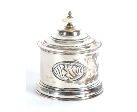 A SILVER TEA CADDYOf cylindrical form, decorated with shell form motifs to the body, the detachable cover having a bone finia