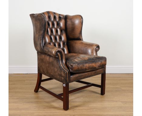 A MID-18TH CENTURY STYLE WINGBACK ARMCHAIRWith faux leather button back upholstery, 82cm; 112cm high