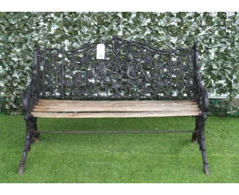 AN EARLY 20TH CENTURY BLACK PAINTED CAST IRON BENCHRelief cast with fruiting vines, 124cm wide; 82cm high