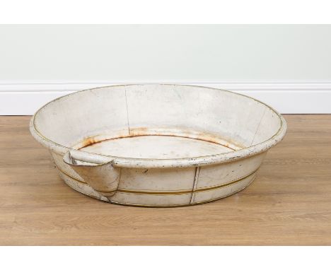 A TOLE PAINTED WASH BASIN20th Century
The circular wash basin with everted lip to one side, painted with gold coloured bands 