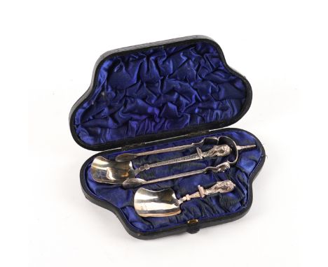 A VICTORIAN SILVER EGYPTIAN REVIVALIST THREE PIECE SETComprising; a caddy spoon,  a preserve spoon and a pair of sugar tongs,