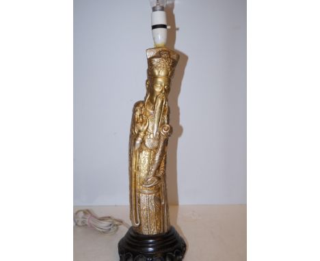 Oriental figure converted into a lamp 