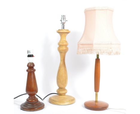 A collection of three 20th century wooden lamp bases. To include a Danish inspired teak and brass example and two turned wood