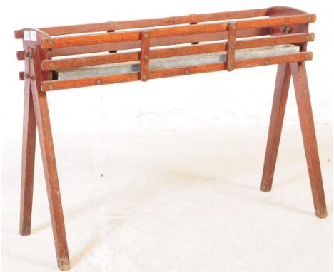 A retro vintage 20th Century teak wood plant stand / planter having a slatted teak wood body with galvanised tray within. All