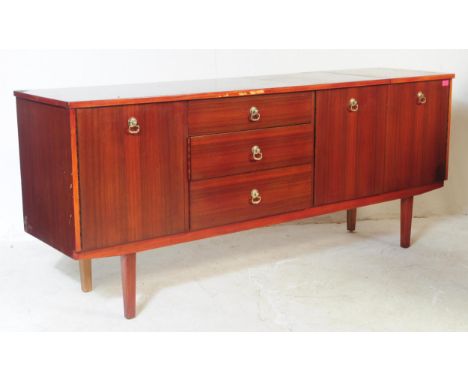 A 1960s mahogany wood sideboard credenza. Of rectangular form with a bank of four drawers to offset centre, flanked by a sing