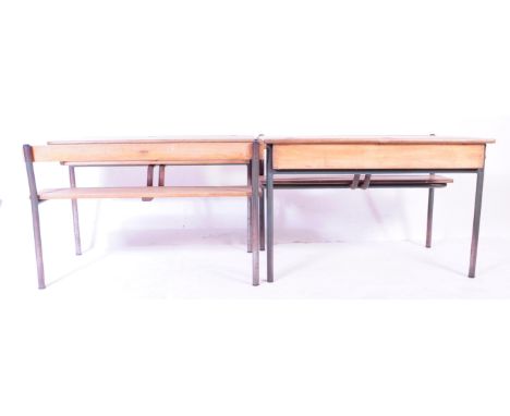 A matching pair of retro mid 20th Century French school desk benches with each comprising of a writing table top with inset r