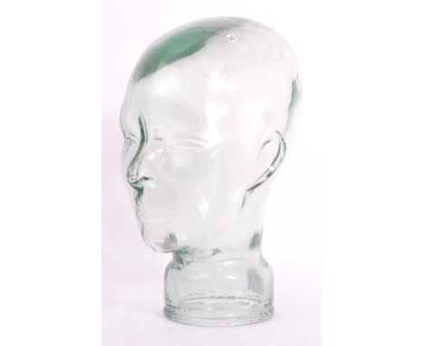 A vintage 20th century clear glass millinery mannequin pressed glass head having moulded features and dappled effect to top. 