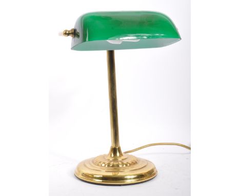A vintage 20th century 1920's style brass and glass bankers lamp. The lamp having a green cased glass shade over hooked brass