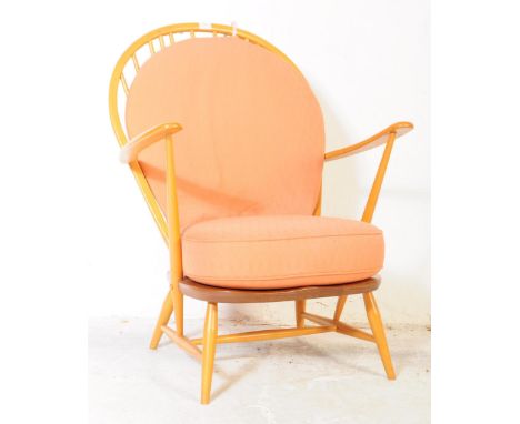 Ercol Furniture&nbsp;- A retro 20th century beech and elm armchair by Ercol. Being raised on turned legs with elbow rests, sa