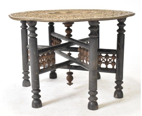 A large early 20th century Indian Benares embossed brass & wooden side coffee table. The table having a shaped top with intri