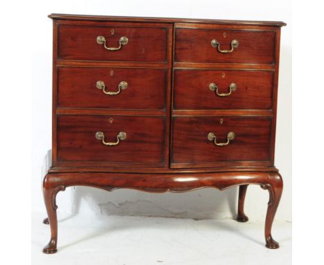 An Edwardian mahogany serpentine fronted cocktail cabinet. Raised on cabriole legs with pad feet having twin faux drawer door