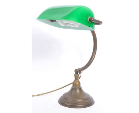 An early 20th century 1920s brass and glass bankers lamp. The lamp having a green cased glass shade over hooked brass shaft u