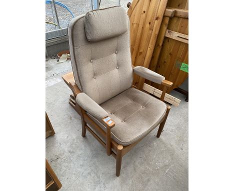 A MOBLER ADJUSTABLE FIRESIDE CHAIR WITH BUTTON-BACK AND SEAT 