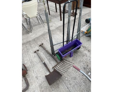 AN ASSORTMENT OF GARDEN TOOLS TO INCLUDE A SHOVEL, A FORK AND A SEEDER ETC 
