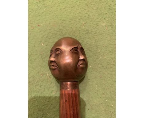 A FOUR FACED BUDDHA TOPPED WALKING STICK 