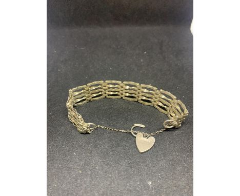 A SILVER FIVE BAR GATE BRACELET WITH HEART CLASP 