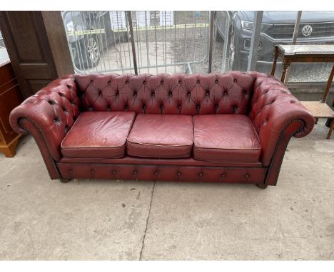 AN OXBLOOD LEATHER LOW BUTTON BACK CHESTERFIELD THREE SEATER SOFA 