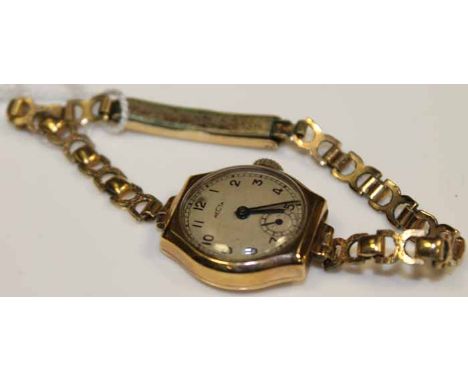 LADY'S ART DECO STYLE NINE CARAT GOLD COCKTAIL WATCH
the silvered dial with Arabic numerals, in nine carat yellow gold case, 