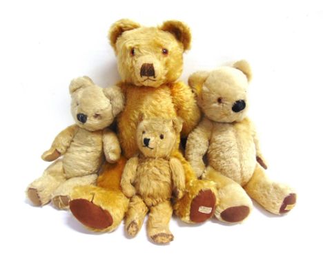 A MERRYTHOUGHT GOLD MOHAIR TEDDY BEAR  with orange glass eyes and a brown vertically stitched nose, on a jointed body with br