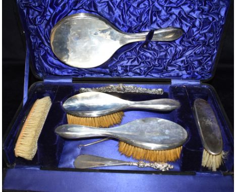 CASED SILVER MOUNTED DRESSING TABLE SET To include sterling silver mounted hair brushes, clothes brushes, hand mirror, emboss