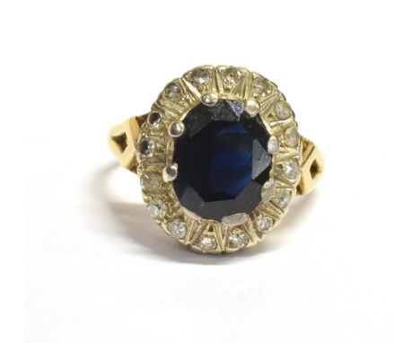 SAPPHIRE &amp; DIAMOND HALO RING Dark blue oval mixed cut sapphire approx 10.7 x 7.0mm, surrounded by a halo of single cut di