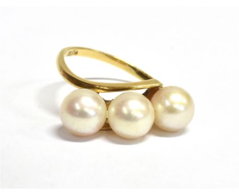 WHITE CULTURED PEARL 14CT GOLD RING Three approx 6.6-6.9mm round white pearls obliquely set in a 14 carat gold ring. Stamped 