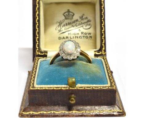 18CT OPAL &amp; DIAMOND HALO RING Central oval bezel set white opal surrounded by a halo of grain set single cut diamonds, es