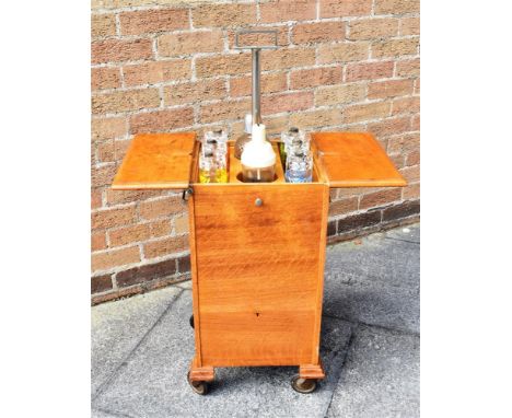 AN ASPREY'S EARLY 20TH CENTURY ART DECO OAK 'ELEVETTE' COCKTAIL CABINET  with central rising section housing cocktail shakers