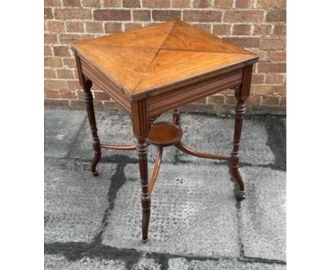 AN EDWARDIAN MAHOGANY CARD TABLE  the baize lined interior with dished counter wells, frieze drawer, on fluted supports unite