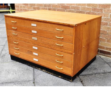 A SIX-DRAWER PLAN CHEST 129cm wide 91cm deep 80cm high Condition Report : damage to one chip board side panel, ( see image) ,