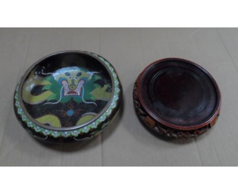 A Chinese cloisonné enamel dragon decorated bowl on wooden plinth,Appears in fine condition,20 cm in diameter 