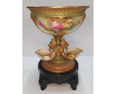 A Royal Worcester blush ivory ground porcelain centre piece in the form of a central bowl on a tapering column, mounted with 