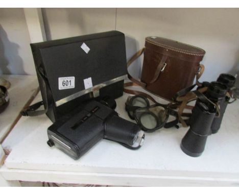 A film camera, binoculars and goggles
