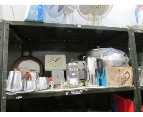 A shelf of kitchenware including stainless steel