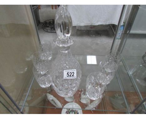 A cut glass decanter and 6 glasses