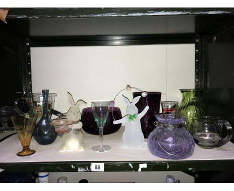 A shelf of assorted glass ware