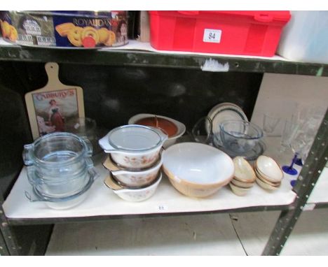 A shelf of kitchen ware including Pyrex