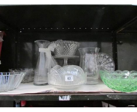 A shelf of assorted glass ware