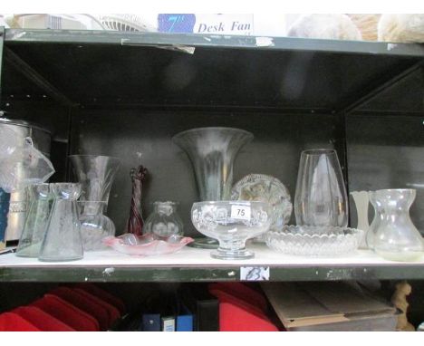 A shelf of assorted glass ware