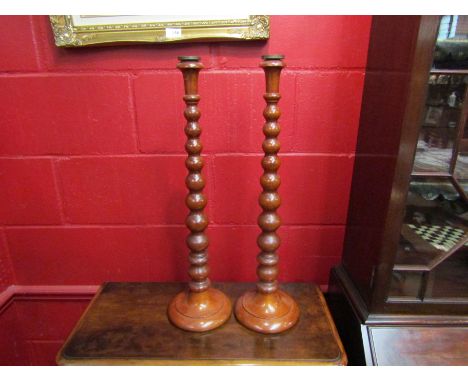 A pair of Victorian style mahogany bobbin-turned candlesticks, 61cm tall