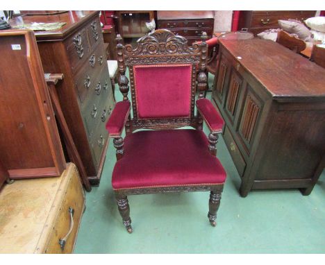 A "James Phillips &amp; Sons, Union St. Bristol" Victorian carved oak throne armchair on turned supports and ceramic castors,