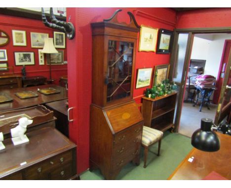 An Edwardian crossbanded mahogany inlaid bookcase bureau, the swan neck pediment and astragal glazed door over a three drawer