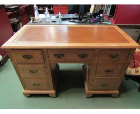 A circa 1900 satin walnut twin pedestal desk the tooled leather writing surface over seven drawers and plinth base on ceramic