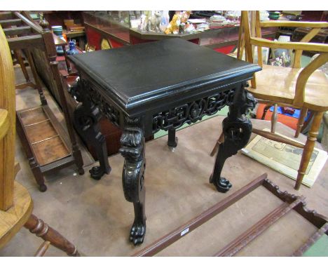 A 19th Century Chinese ebonised lamp table the pierced frieze and carved dragon legs on lion paw feet, 62cm tall x 57cm wide 